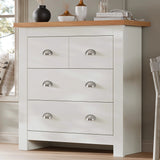 [White] Shaker chest of drawers angled by bedroom window, oak top with vases, silver cup handles, white frame