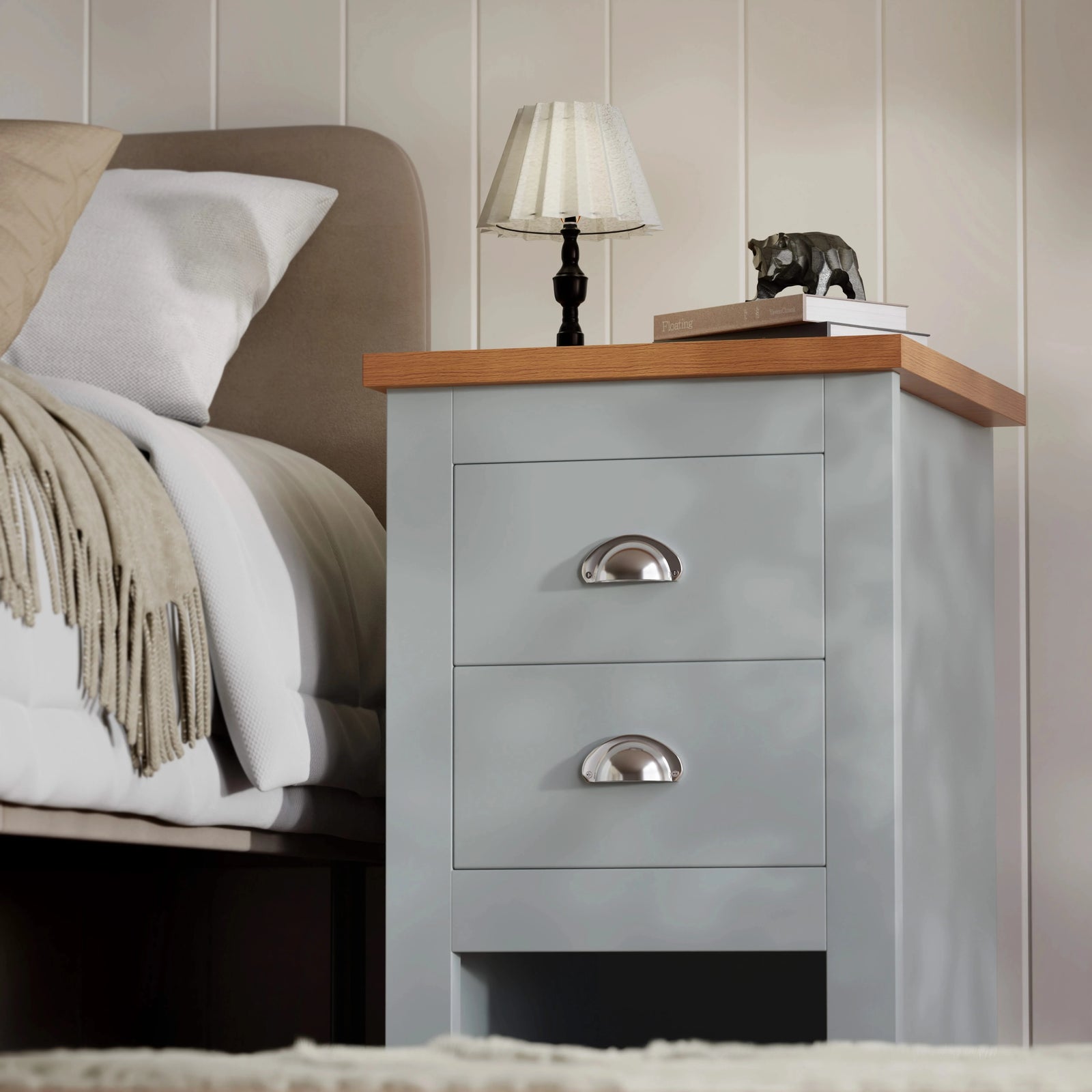 [Grey] grey nightstand with oak-effect top and two chrome cup handles, table lamp and small bear figurine on top
