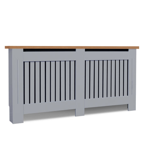 Tilted front angle of extra large radiator covers in grey with oak top shown in a bright room blending size & sophistication.