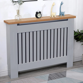 [Medium | Grey] Medium grey radiator cover with oak top and vertical slats, styled with toys and clock, perfect for children's rooms or living areas.