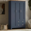 [Blue] Shaker triple wardrobe in navy blue with oak top, three panelled doors and two base drawers, angled view.