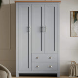 [Grey] Shaker triple wardrobe front view in grey, 3 panel doors with T-bars and 2 cup-handle drawers, oak top.