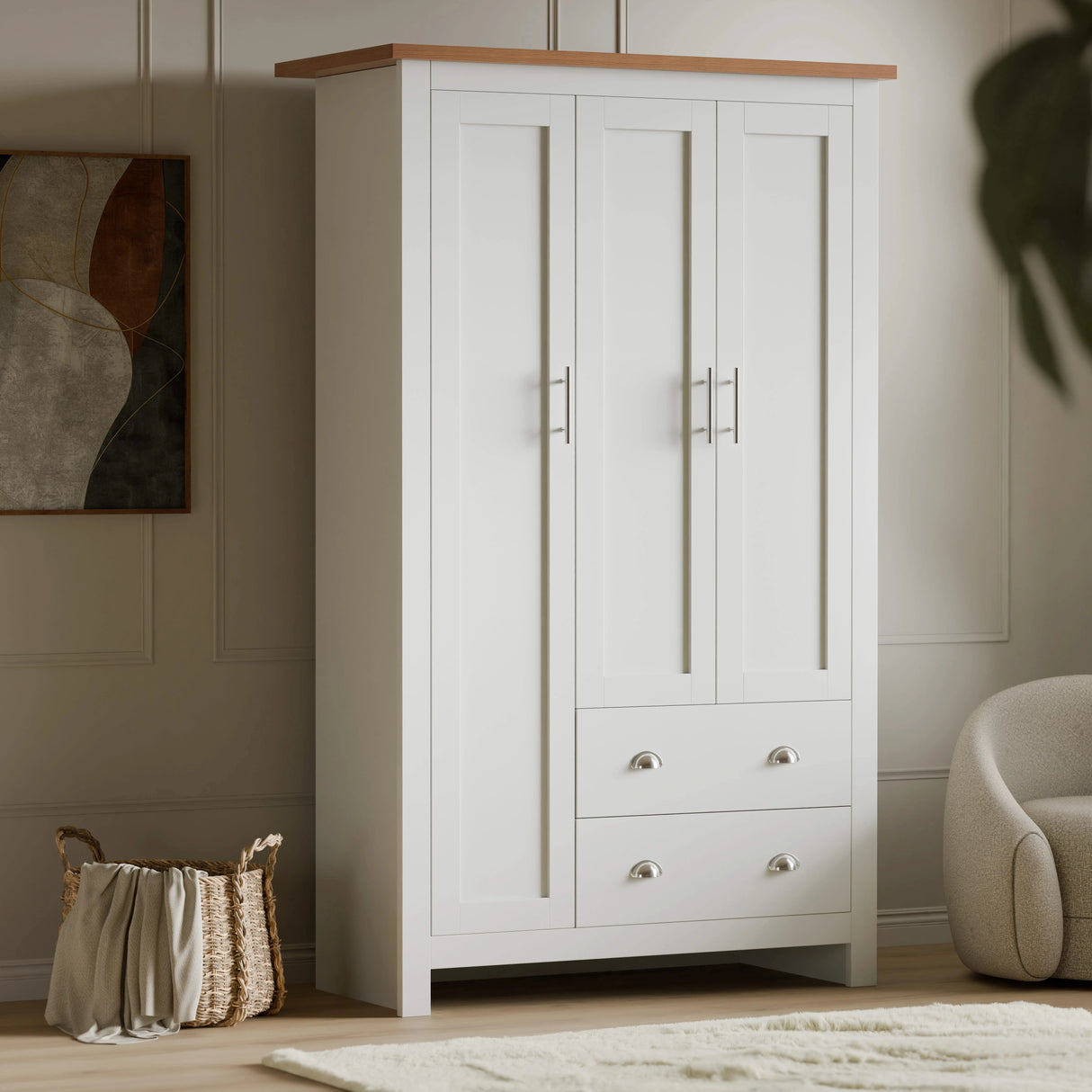 [White] White Shaker triple wardrobe beside woven basket, three panelled doors and two cup-handle drawers