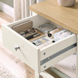 [White] Close-up of the open drawer holding glasses, books and small bedside essentials