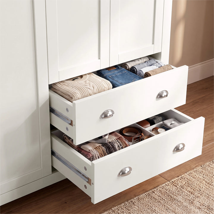 [White] Close-up of open lower drawers on the Shaker White Triple Wardrobe showing inner storage and silver cup handles.