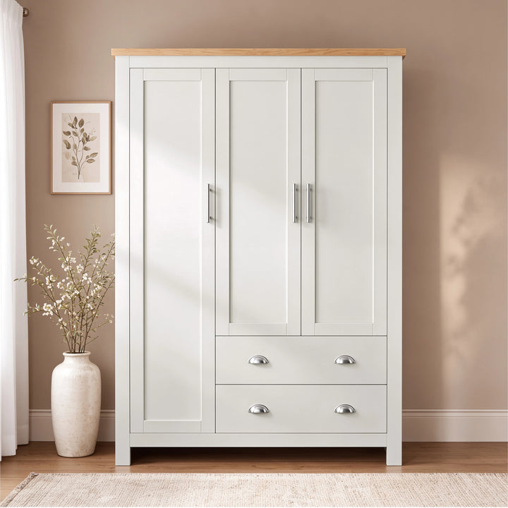 [White] Front view of the Shaker White Triple Wardrobe with Drawers and Shelves showing silver cup handles and bar pulls.