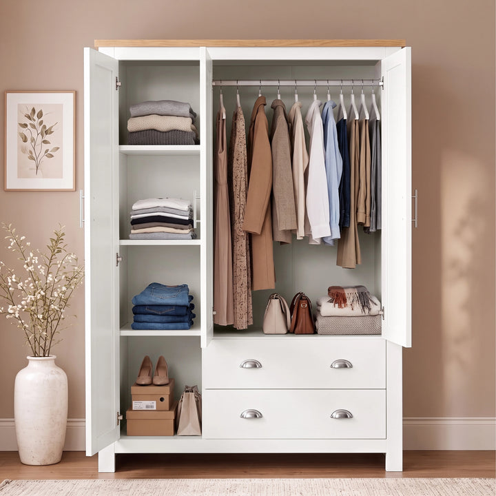 [White] Open Shaker White Triple Wardrobe displaying hanging clothes, organized shelving space, and two lower drawers.