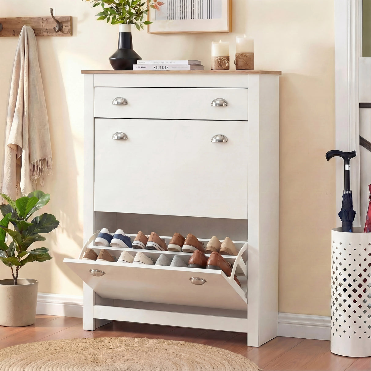 [White] Slim hallway shoe cabinet in white with bottom flip-down door open exposing two rows of shoes on angled racks