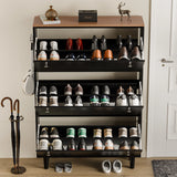 Three door shoe cabinet with doors in black oak top open, showing 24 shoes and music unit placed on top shelf area.
