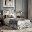 [Single | Silver] Silver crushed velvet ottoman bed dressed with grey throw, abstract beige art on panelled wall behind