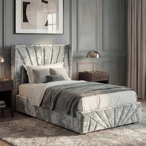 [Single | Silver] Silver crushed velvet ottoman bed dressed with grey throw, abstract beige art on panelled wall behind