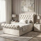 [Single | Beige] Angled bedroom view of Chesterfield bed with tufted headboard, footboard, curtains, and bedside table.