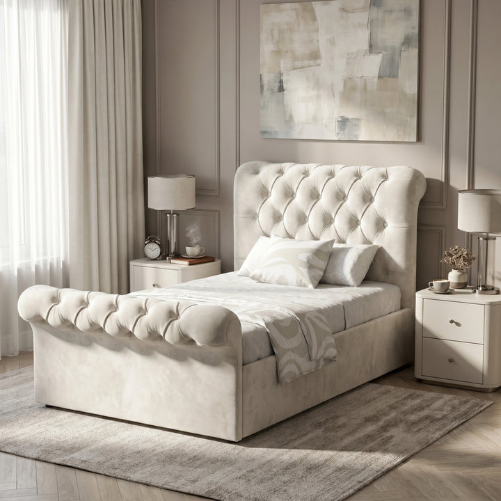 [Single | Beige] Angled bedroom view of Chesterfield bed with tufted headboard, footboard, curtains, and bedside table.