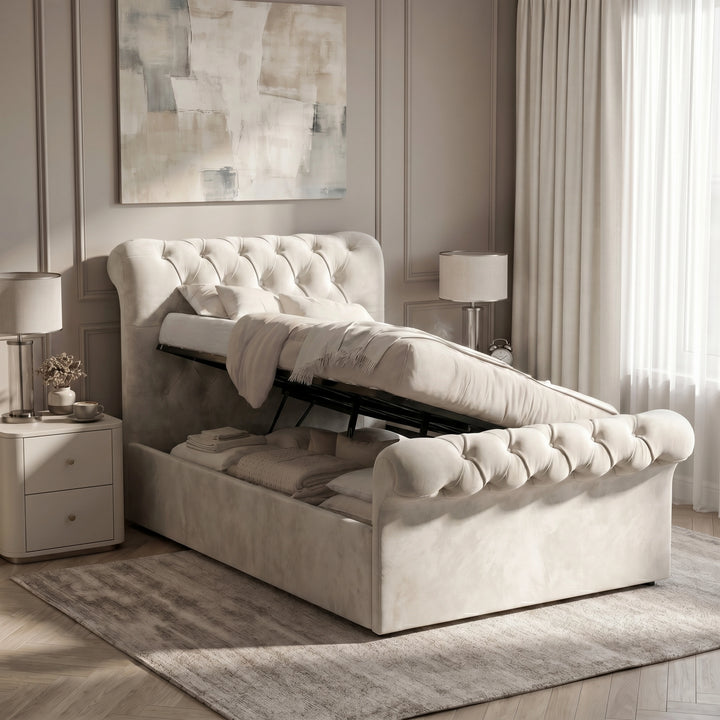 [Single | Beige] Chesterfield bed with ottoman storage open, showing gas struts, bedding, footboard, and side tables.