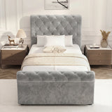 Front elevation of single grey upholstered storage bed with cushioned frame and low footboard