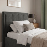 [Single | Grey] Velvet ottoman storage bed headboard detail with stitched panel sections and stacked pillows below