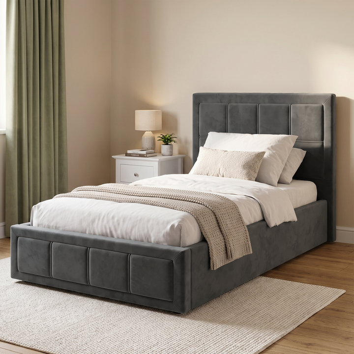 [Single | Grey] High-angle perspective view of the Single Grey Velvet Ottoman Storage Bed Frame placed on a woven cream rug.