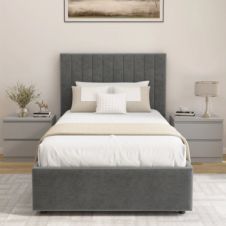 Gray upholstered bed with white bedding in a bedroom setting.
