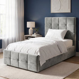 [Single | Grey] tufted velvet bed frame with a tall matching headboard and footboard, styled in a modern bedroom with white nightstands, beige curtains, and wall sconces.