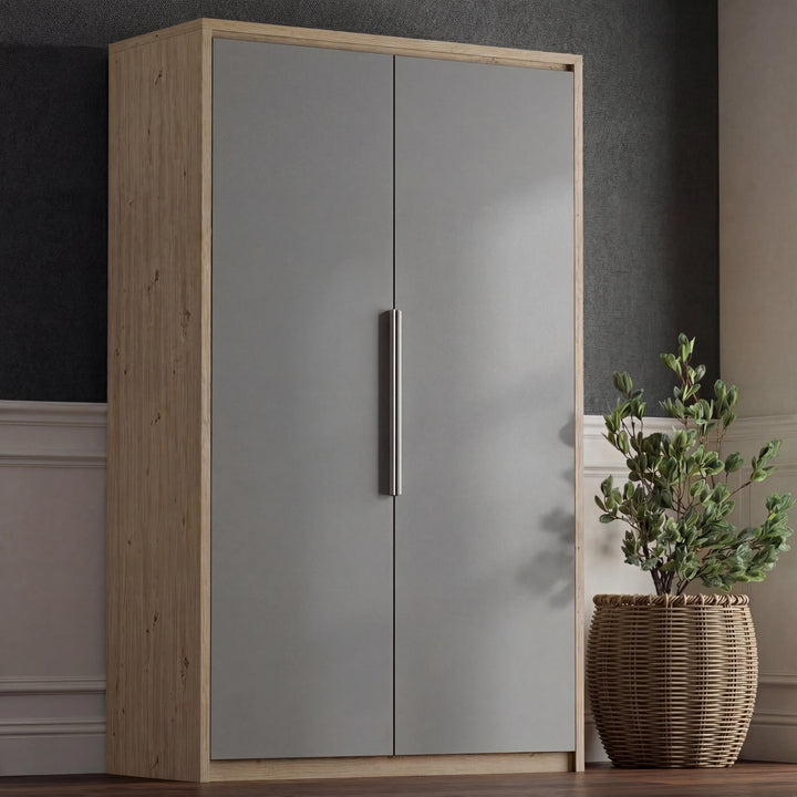 [Oak+Grey] Front view of Skova wardrobe in oak and grey, both grey doors shut with woven planter beside it