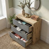 [Oak+Grey] All three drawers of Skova chest of drawers pulled open showing folded items and books inside