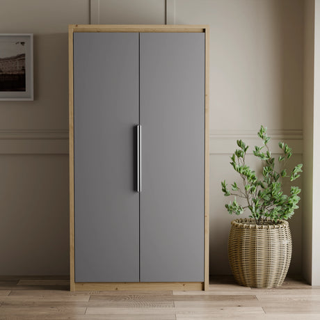 [Oak+Grey] Skova 2 door wardrobe with oak frame and grey doors closed, vertical chrome bar handles, woven planter alongside