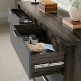 Close-up of wooden grey finish bedroom drawers with partially open drawers displaying jars and packaged items in bright room