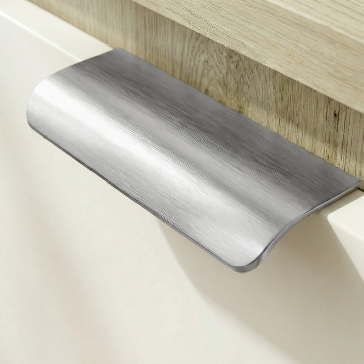 [Oak+White] Detail of recessed metal pull on white drawer front of Skova chest of drawers below oak top