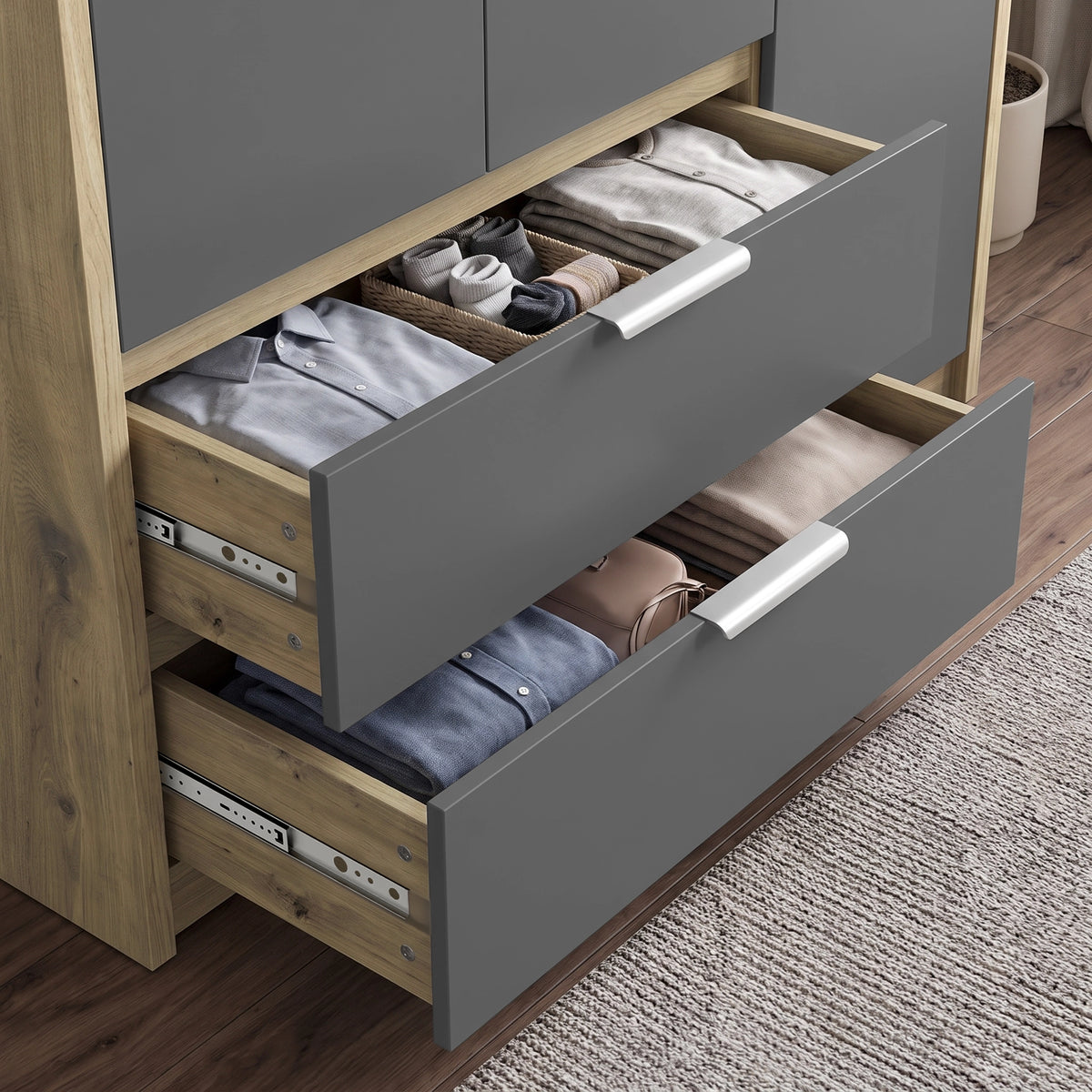 [Grey] wardrobe with two drawers pulled open to show neatly folded clothing and storage accessories inside. The dresser has a gray front and natural wood sides, with white handles.
