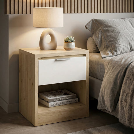 Bedside cabinet in oak finish with white drawer placed against a wall in a contemporary bedroom