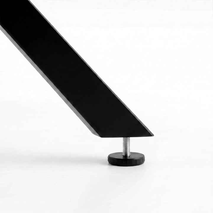 [White] Skyra dining table set leg detail showing floor pad below the black angled support