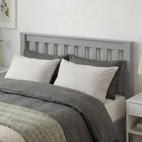 Grey wooden single bed frame with slatted headboard, soft bedding, and a minimalist bedroom design