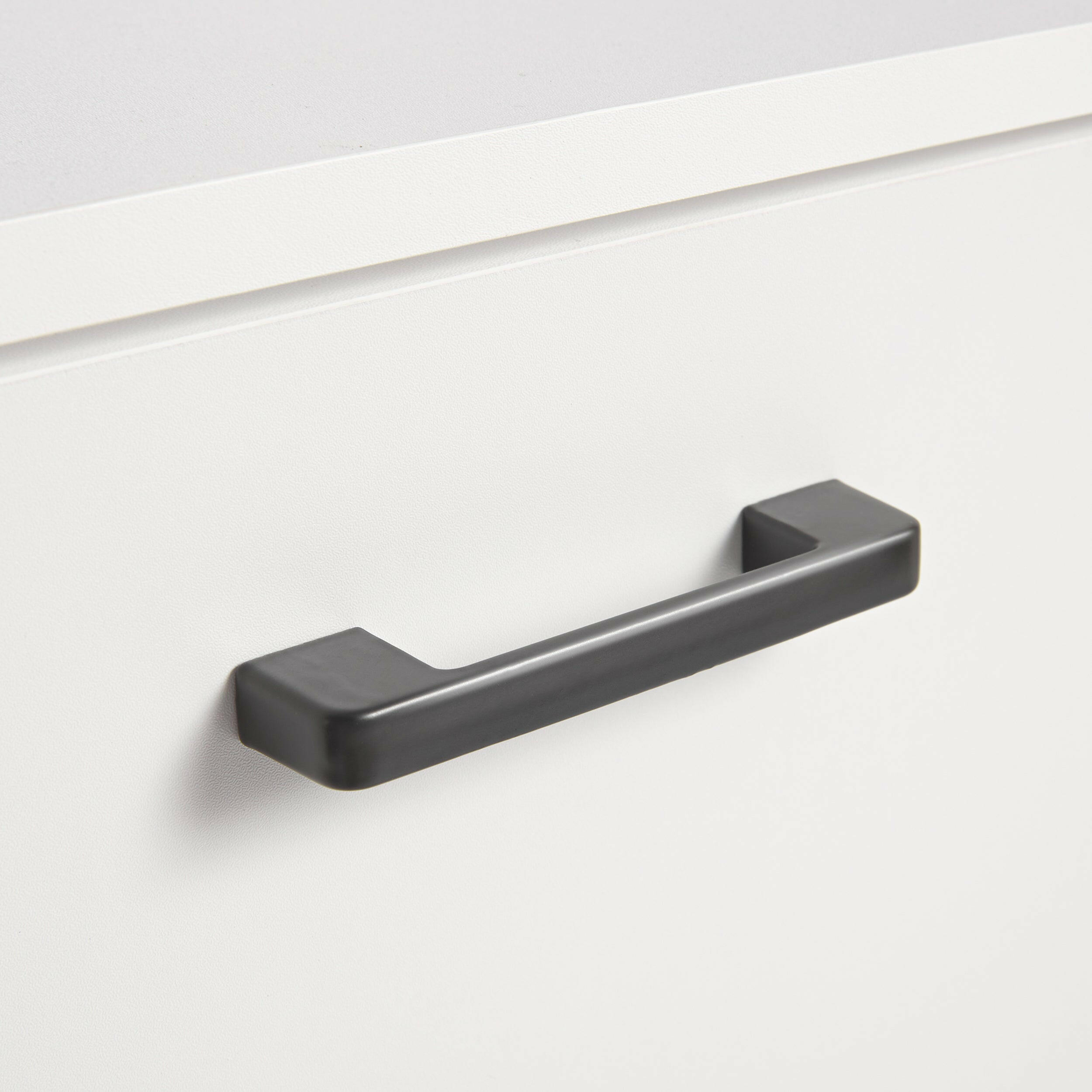 close-up view of a black handle on a white slim shoe storage cabinet.