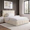 [Small Double | Beige] Angled lifestyle view of the Small Double Beige Velvet Ottoman Storage Bed Frame against a dark paneled feature wall.