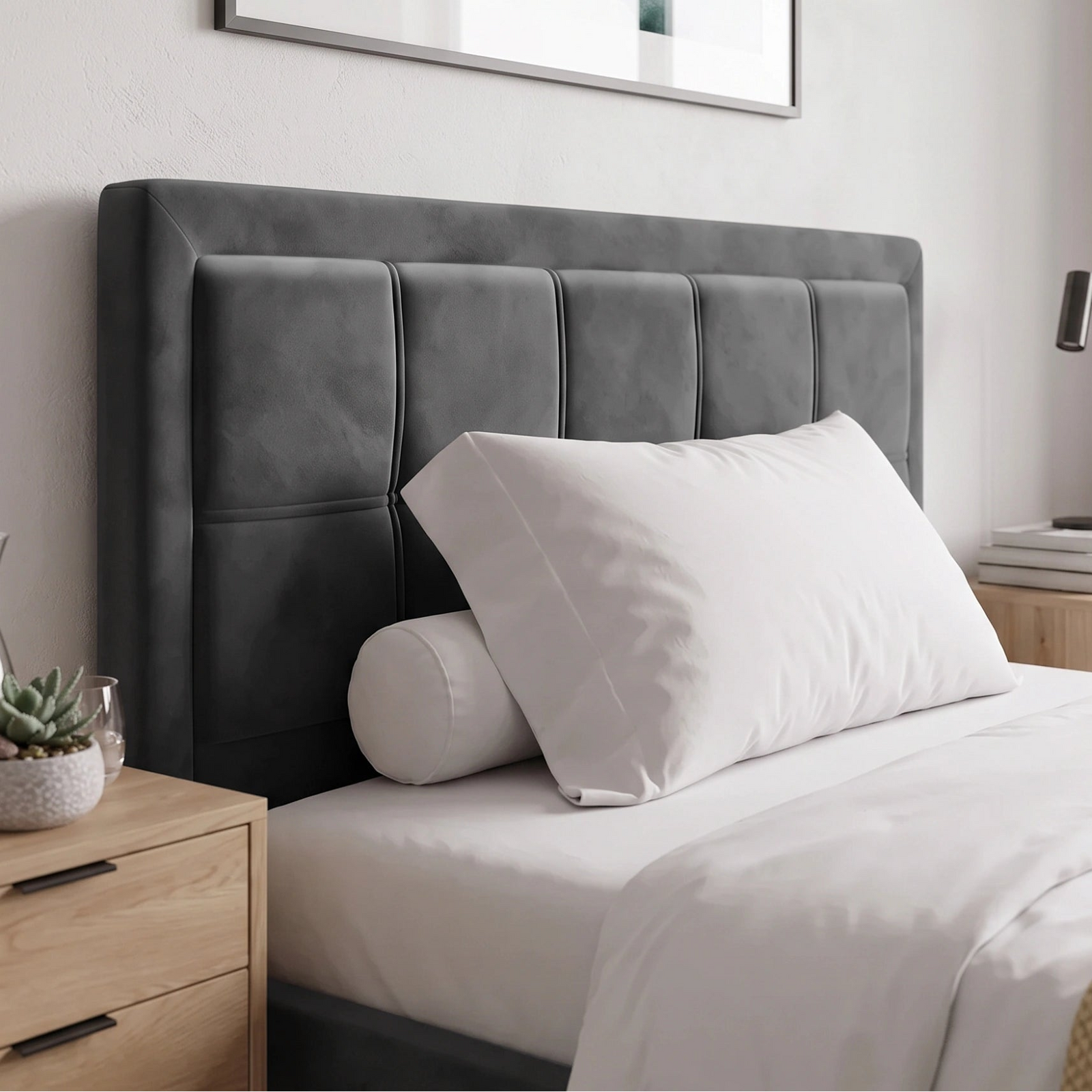 [Small Double | Grey] bed with a grey tufted upholstered headboard, dressed in white bedding with a white pillow and cylindrical bolster pillow, styled in a minimalist bedroom setting.