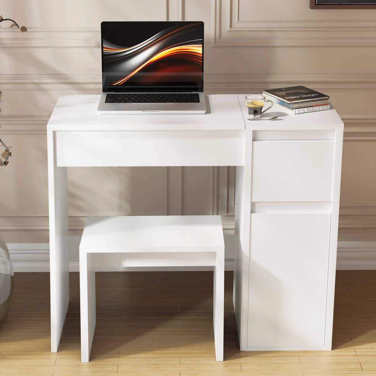 White desk with a laptop and small stool in a room with wooden flooring and beige walls.