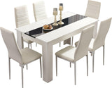 Small white dining table and chairs, compact and elegant, ideal for modern dining spaces.