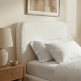 [White | Single] White boucle ottoman bed headboard texture close-up, looped curled fibres on rounded puffed panel