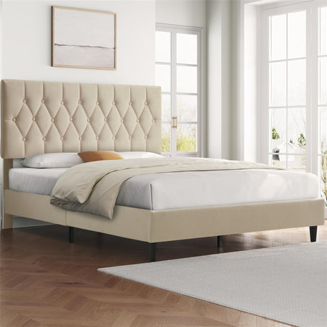 Soft bed frame uk with tufted beige headboard in a bright bedroom with large windows.