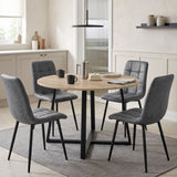 [Sonoma Oak] Round dining table set for four with mugs and plates, surrounded by grey chairs in a kitchen setting.