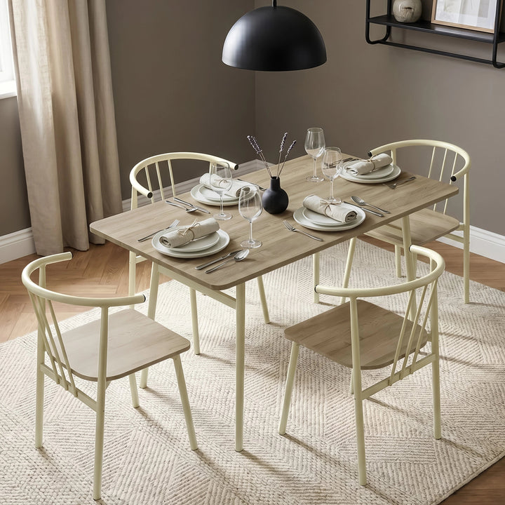 [Sonoma Oak] Torvi dining scene with four place settings, cream chairs, a textured rug, and a black pendant light.
