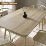 [Sonoma Oak] Torvi dining table and chairs overhead close-up showing oak-effect tabletop surface with a small vase and four cream metal arm chairs around it
