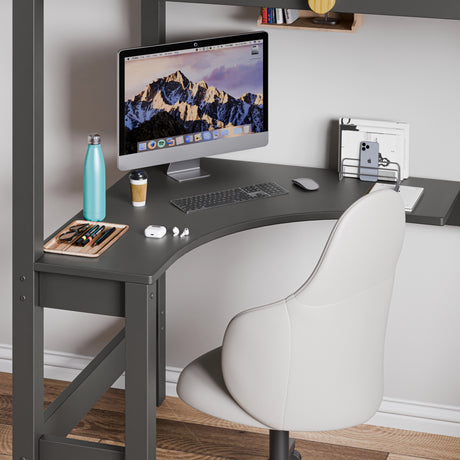 Space-saving corner workstation with neatly organised computer setup and a grey chair under the dark grey bunk bed