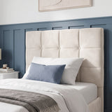 [Single | Beige] upholstered headboard in a warm belge velvet fabric, shown on a bed in a styled bedroom with blue paneled wall, white bedding, and a blue accent pillow.