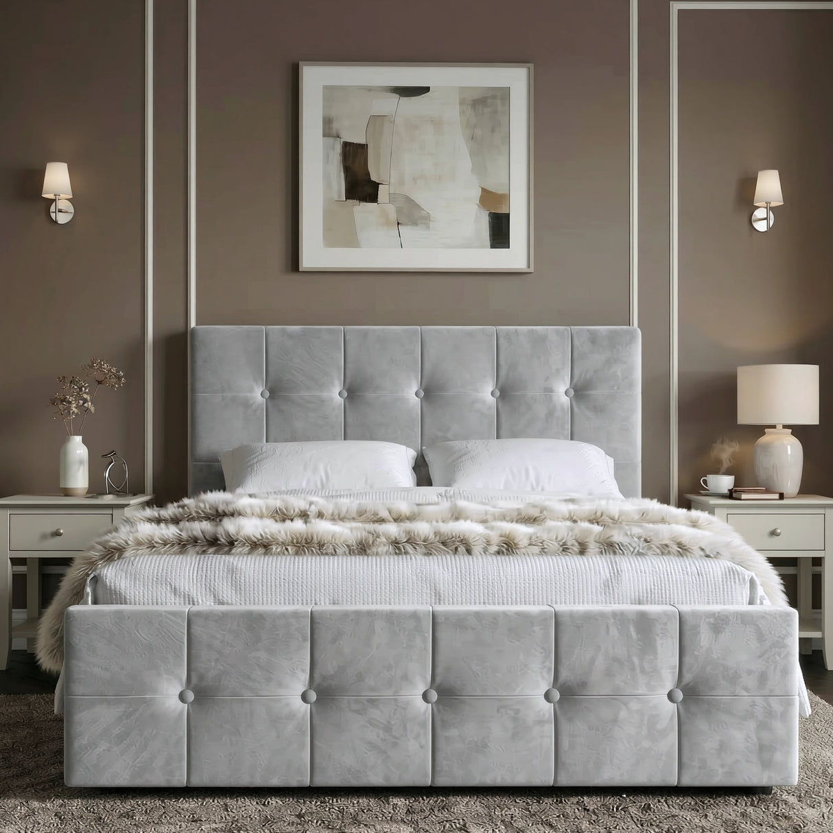 [Double | Grey] Front view of tufted ottoman bed centred between grey nightstands with brass wall sconces and abstract art