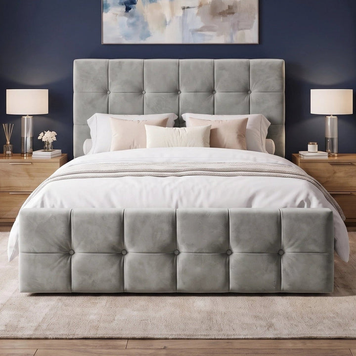 [Double | Grey] Front view of tufted ottoman bed centred between grey nightstands with brass wall sconces and abstract art