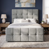 [Small Double | Grey] tufted velvet bed frame with a matching headboard and footboard, styled in a modern bedroom with a dark blue wall, wooden nightstands, and matching lamps.