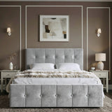 [Small Double | Grey] Front view of tufted ottoman bed centred between grey nightstands with brass wall sconces and abstract