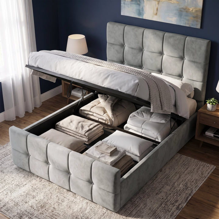 [Small Double | Grey] tufted velvet storage bed with its headboard and footboard lowered to reveal neatly folded bedding and towels inside the raised frame, shown in a styled bedroom setting