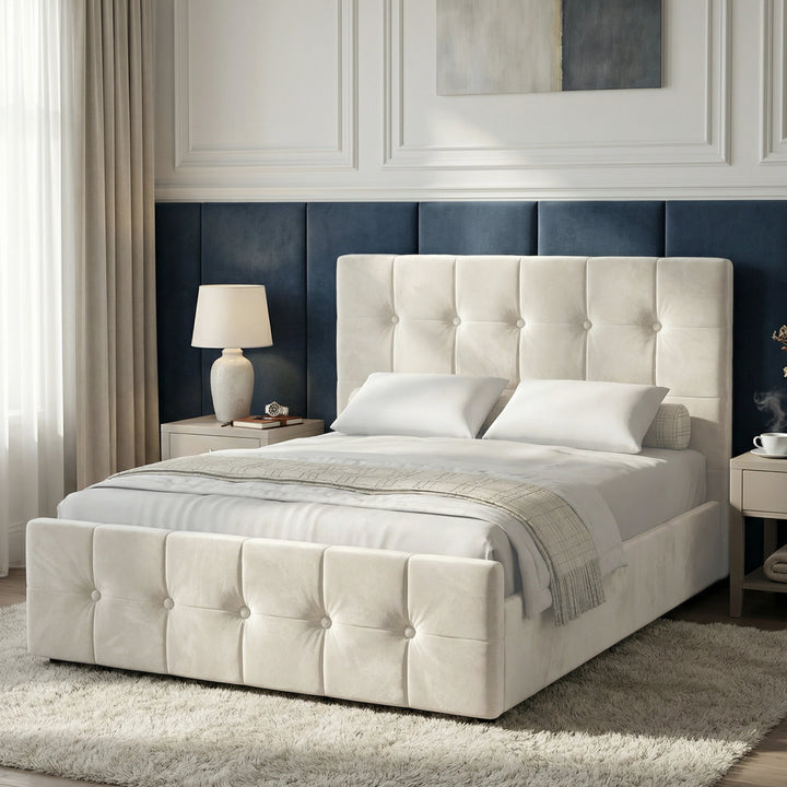 [Double | Beige] Square ottoman bed angled in bedroom, grid-tufted headboard and footboard with cream bedding and lamp